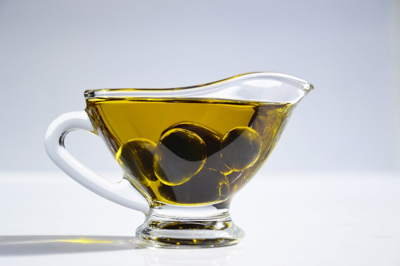 Photo of Olives in a Cup full of Olive Oil
