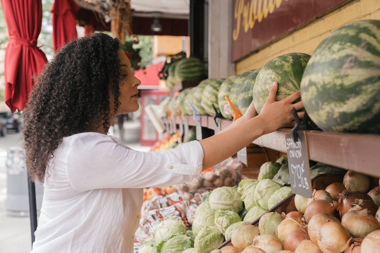Woman Wearing a White Top Choosing Watermelons