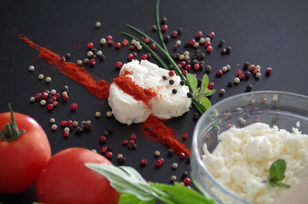 image if cheese decorated with red pepper and green leaves