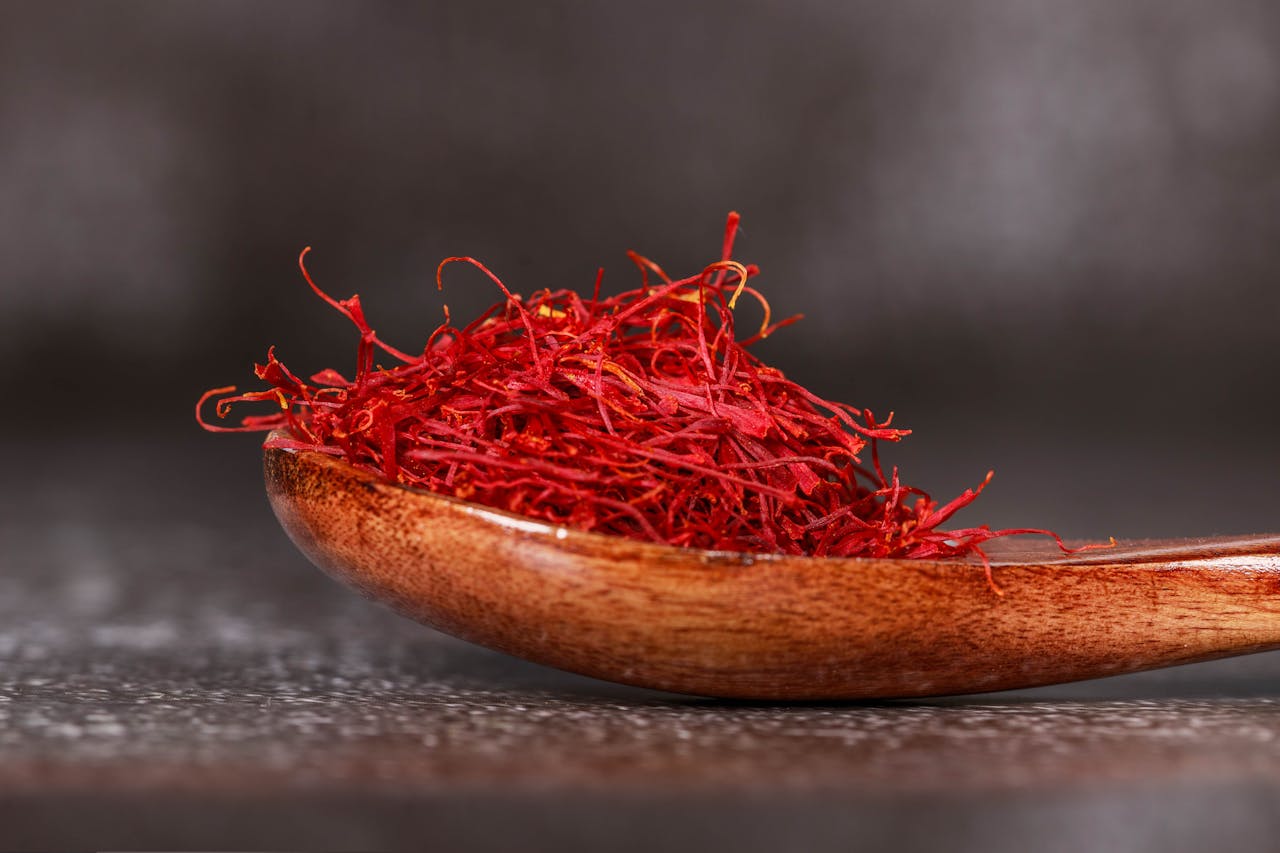 Red Saffron Spice on Brown Wooden Spoon
