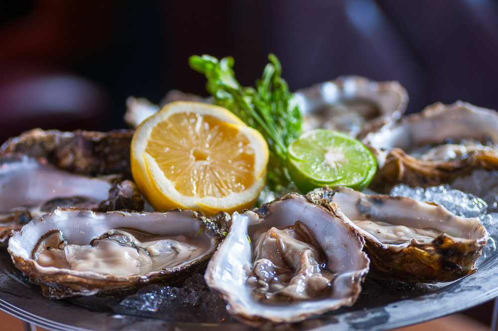 Fresh oyster in dish with lemon and lime