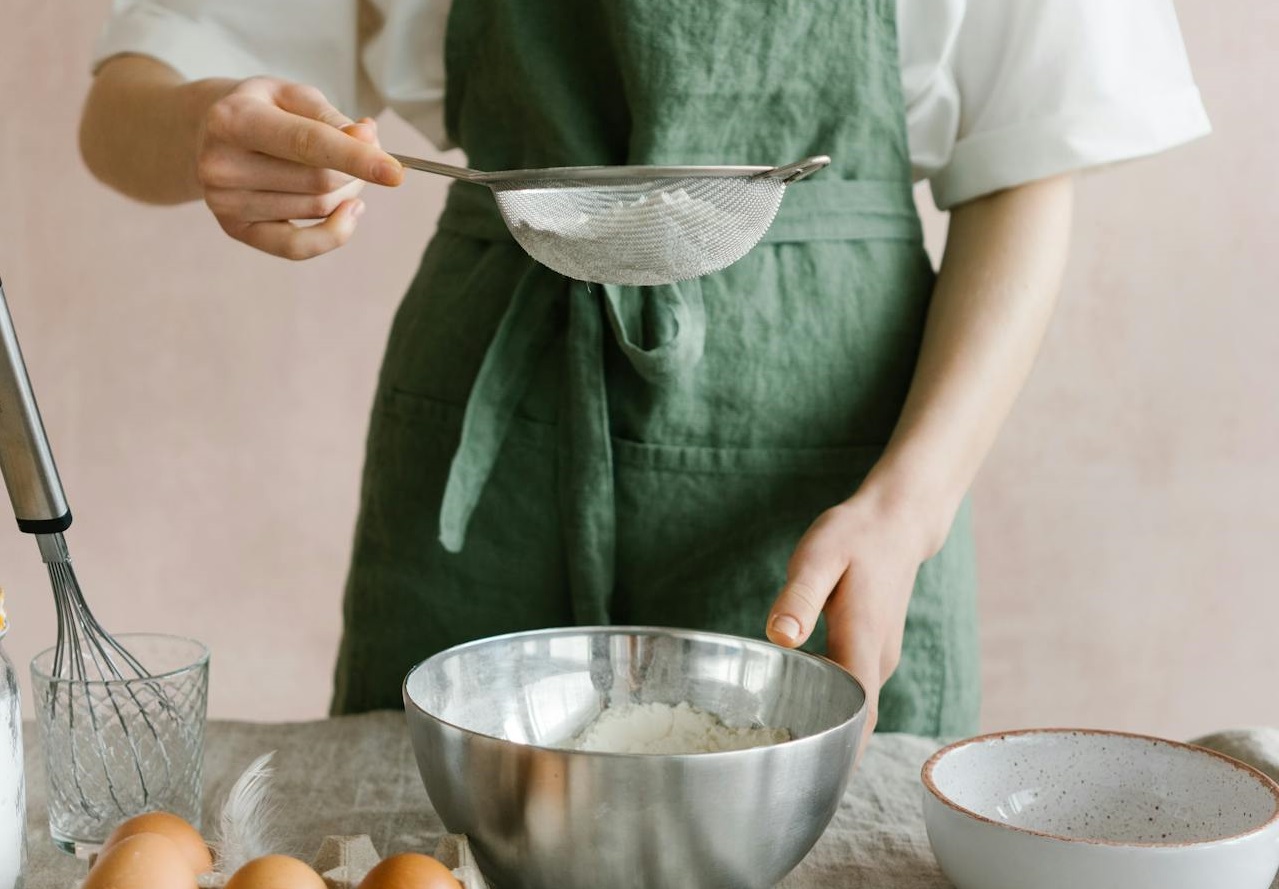 Person Holding a Strainer with Flour