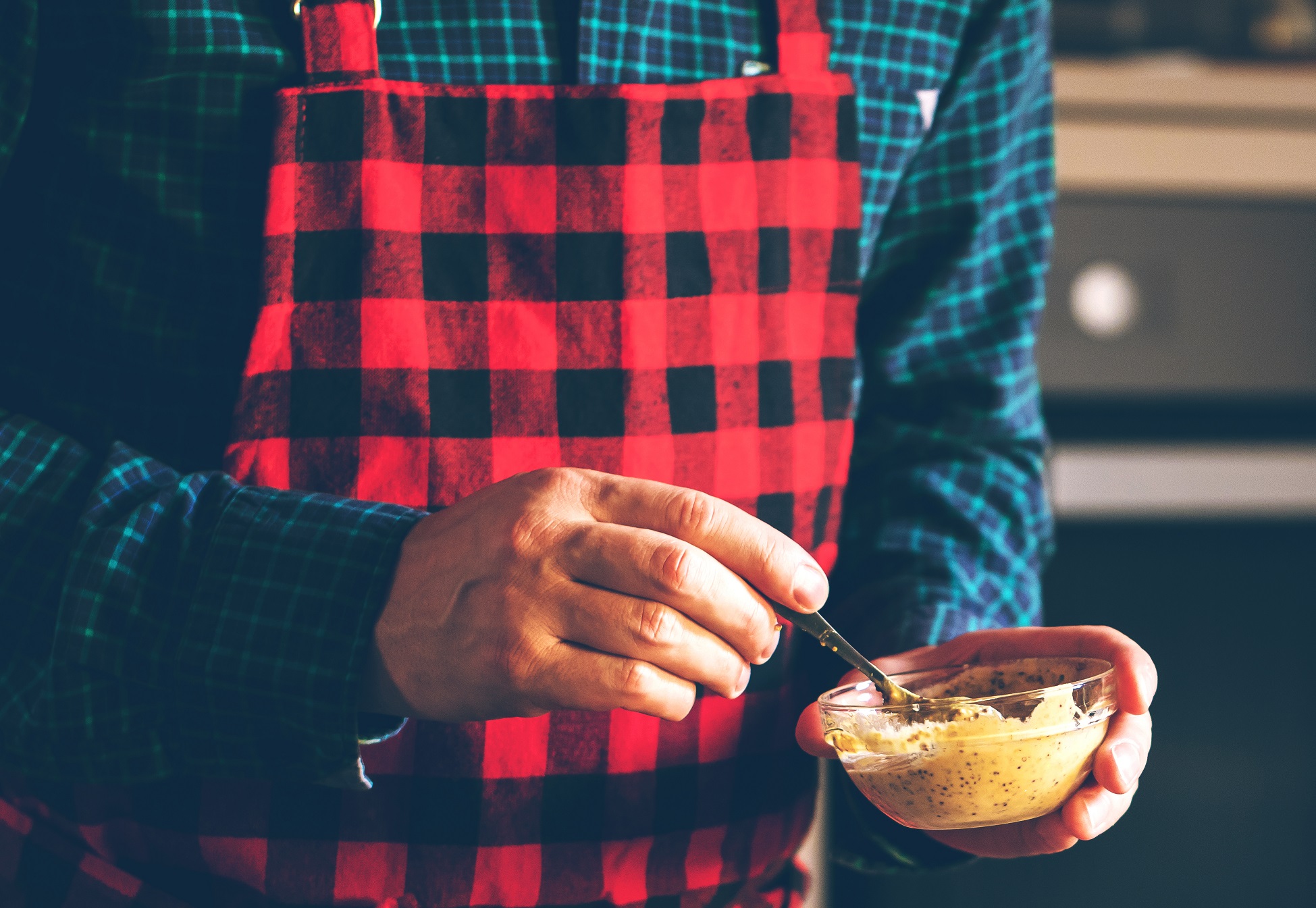 Man cooking with bowl with mustard.