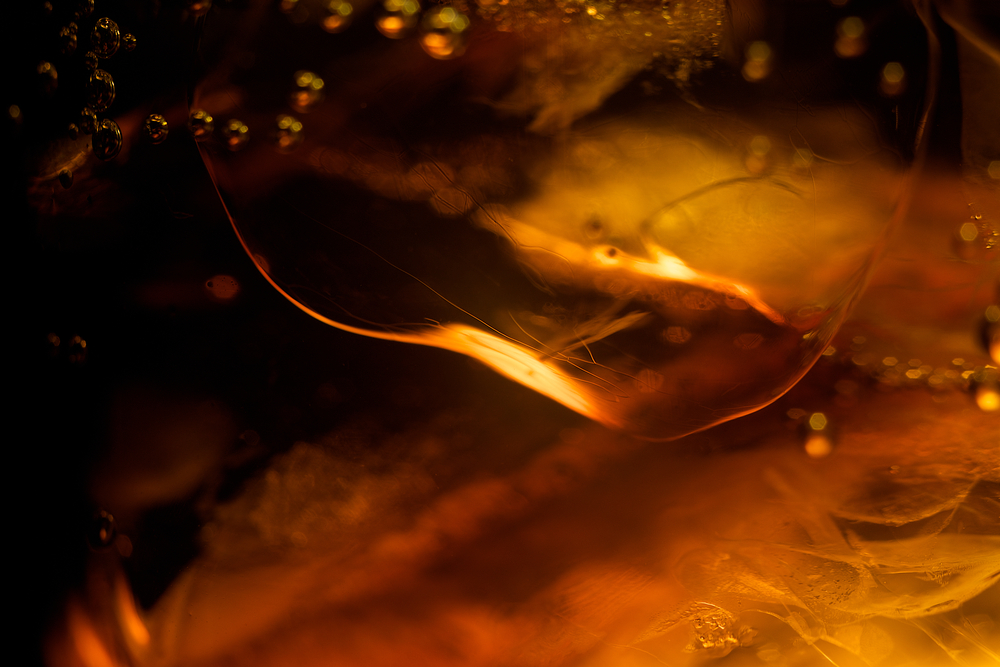 Ice cube in whiskey texture background