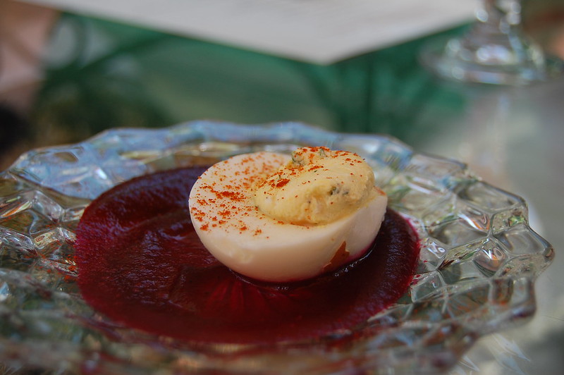 Close-up Photo Deviled egg in tomato sauce placed in a crystal plate