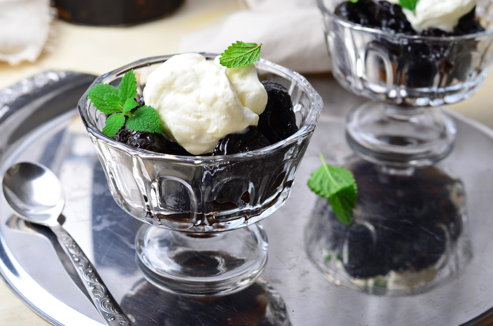 Prunes Stuffed With Walnut And Served With Whipped Cream