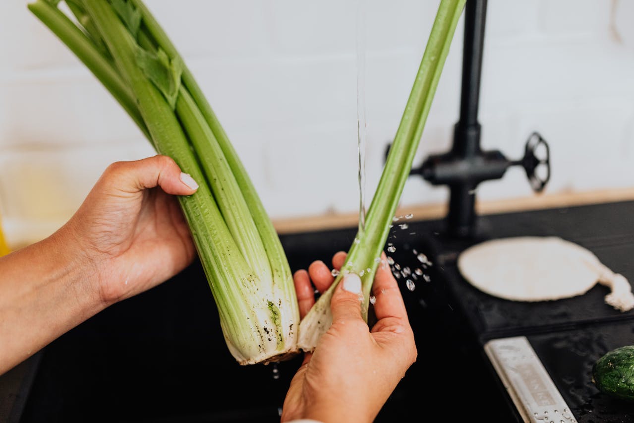 image of woman washing Celery