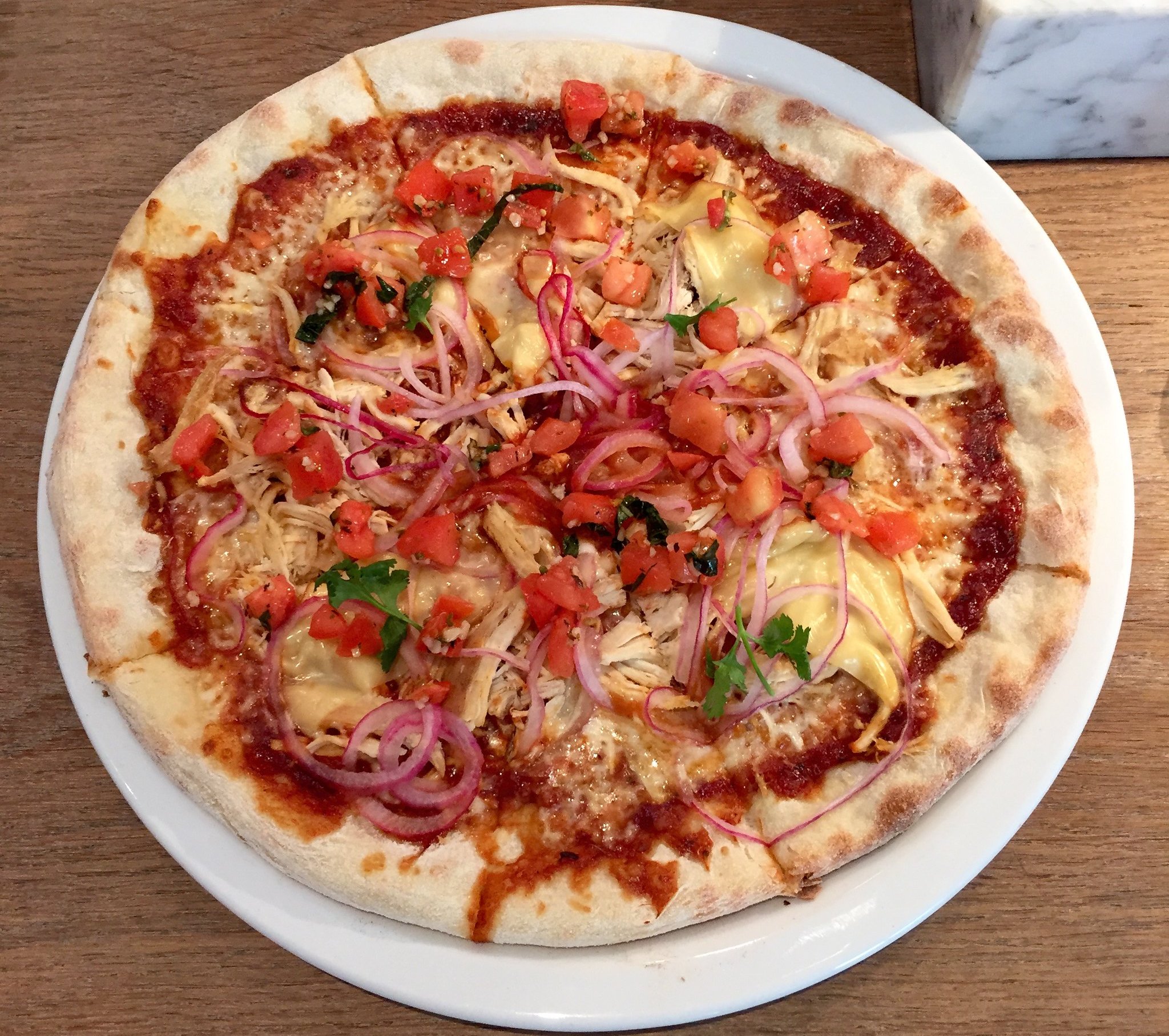 Close-up Photo of BBQ Chicken Pizza on a white plate
