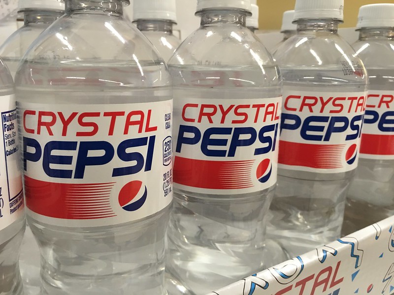 Close-up Photo of Crystal Pepsi Bottles on a market rack