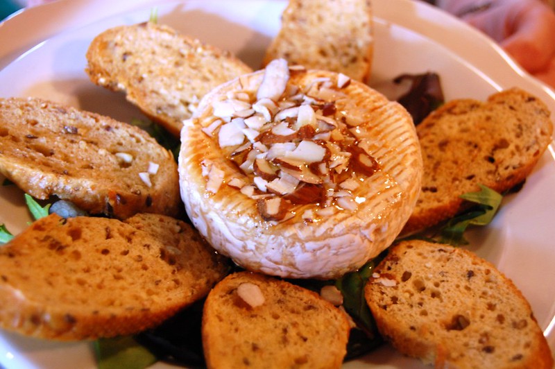 Close-up Photo of baked brie appetizer on a white plate