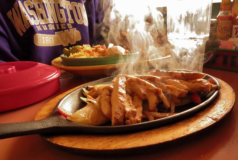 Close-up Photo of Sizzling Fajitas placed on a wooden board