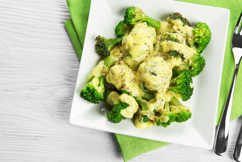 Close-up Photo of White plate of delicious broccoli with cheese cream