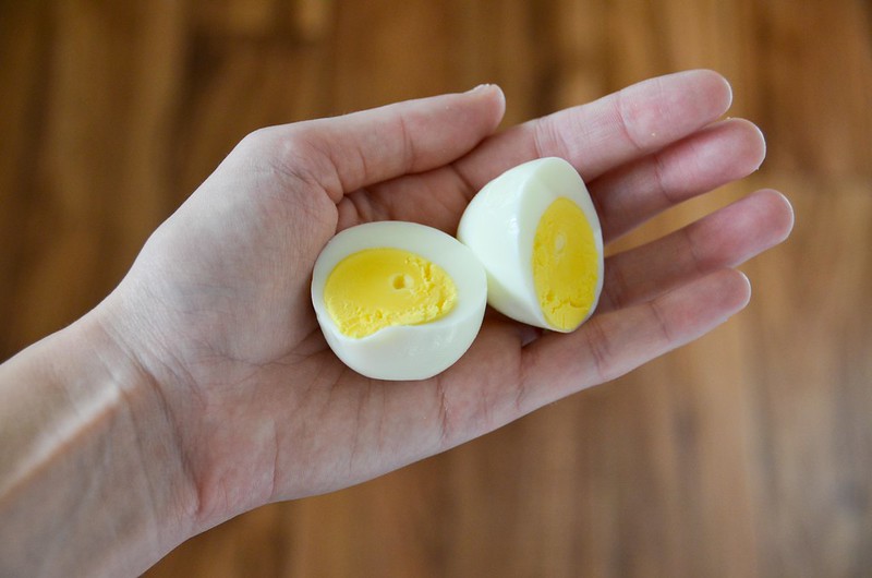 person holding boiled egg in his hand