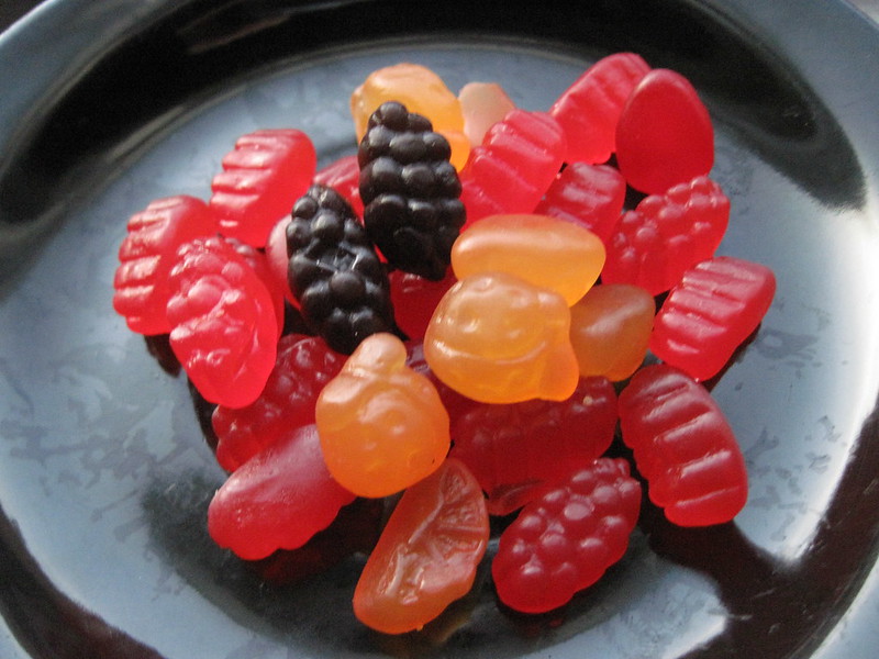 Close Up Photo of Fruit Gummies on a black plate