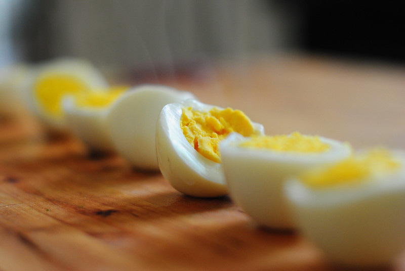 Hard boiled eggs on a wooden plate