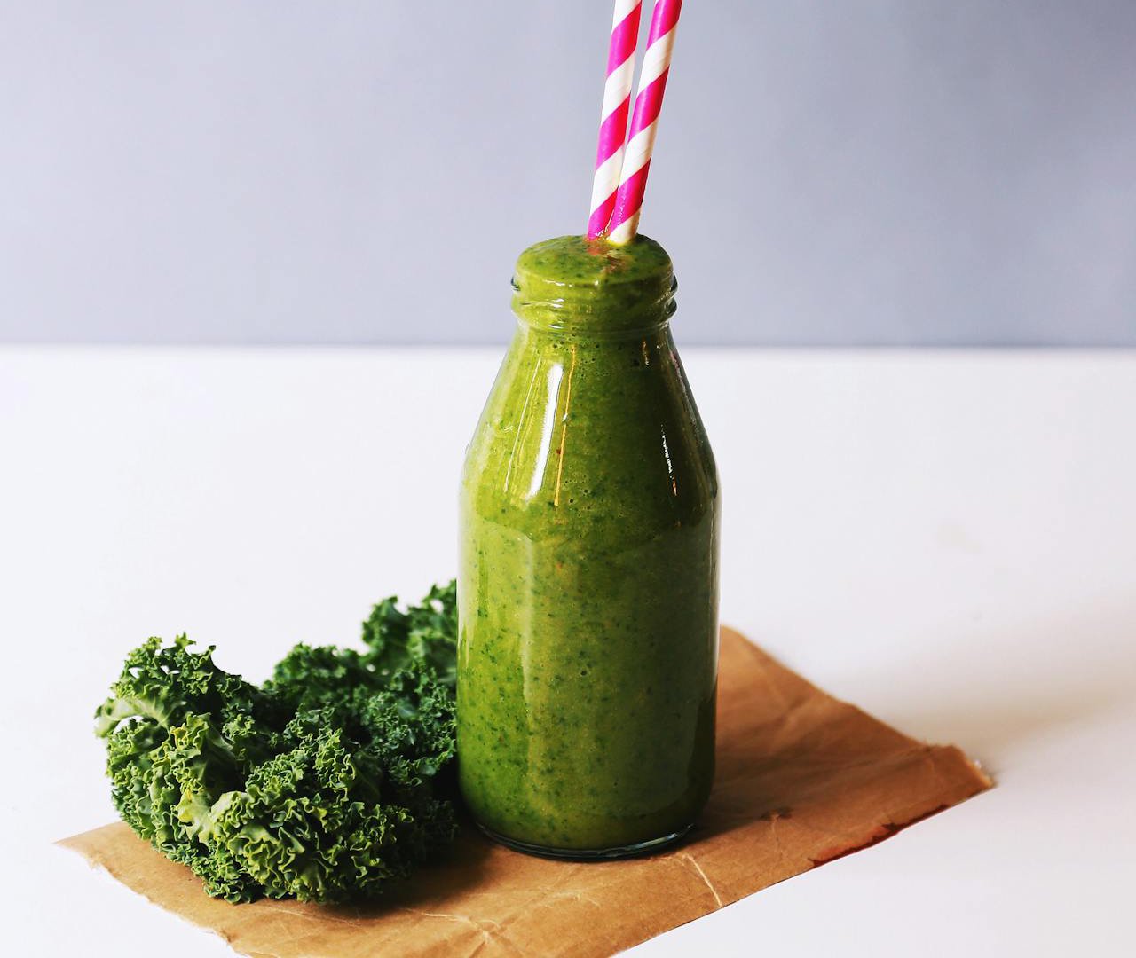 Close-up Photo of Clear Glass Bottle Filled With Broccoli Shake
