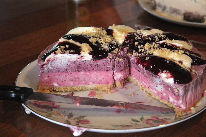 Close Up Photo of berry cheesecake and a knife on a plate