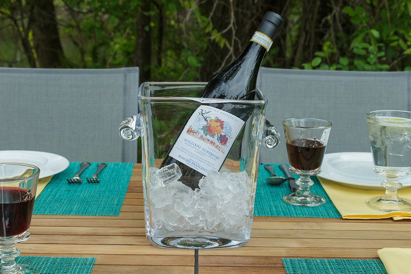 Close Up Photo of Ice Bucket with wine placed on a table