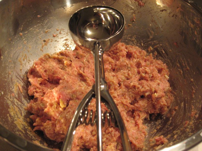 Close Up Photo of ground meat in a metal bowl with Ice Cream Scoop