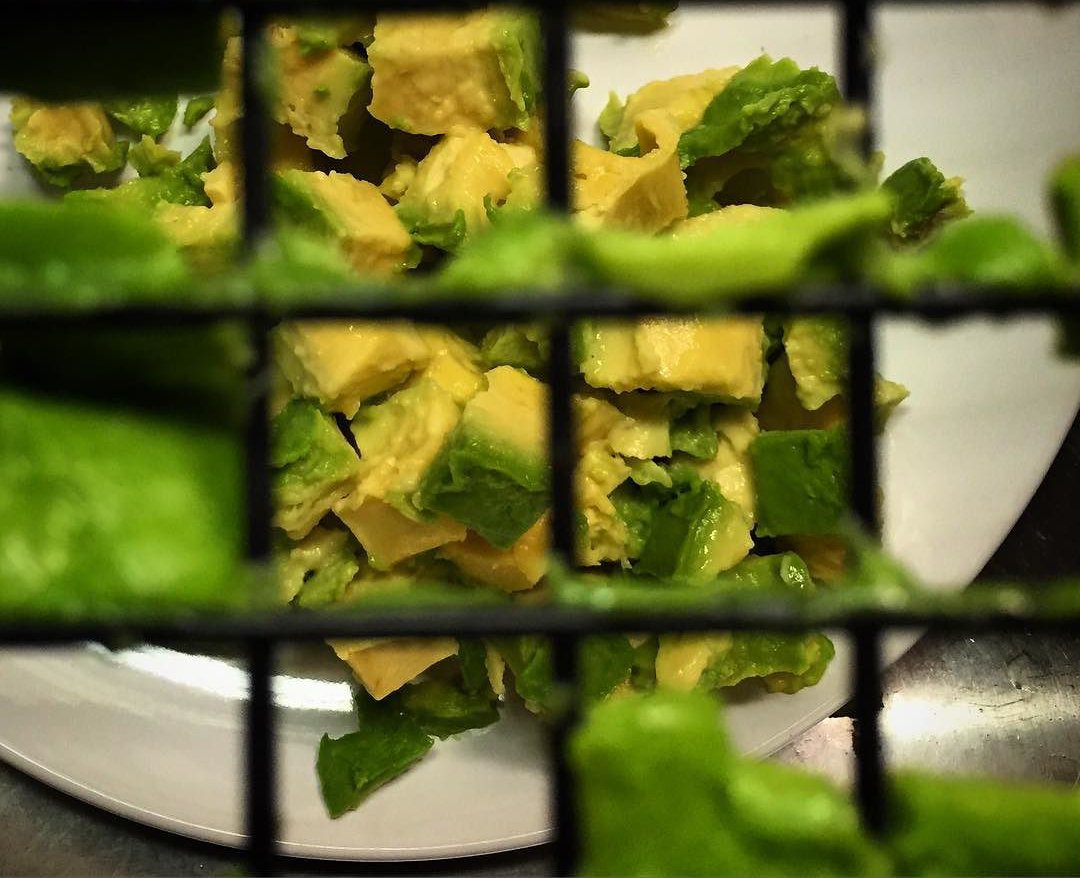 Overhead Photo of Avocado Pushed through a cooling rack.