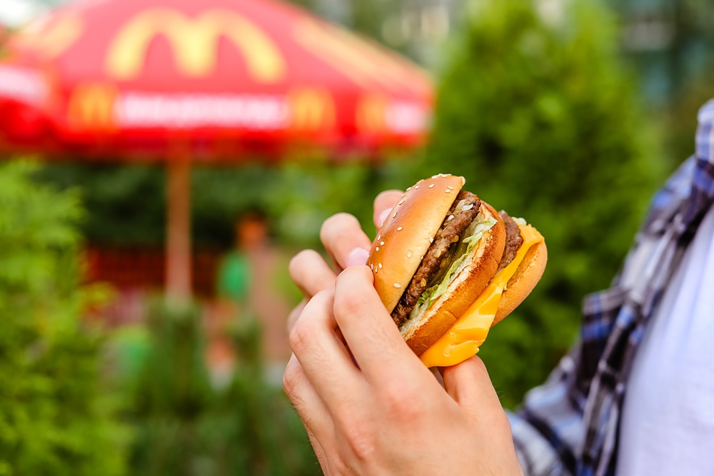 man holding delicious juicy fresh burger