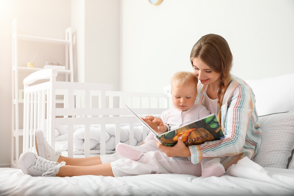 mother reading book to her baby