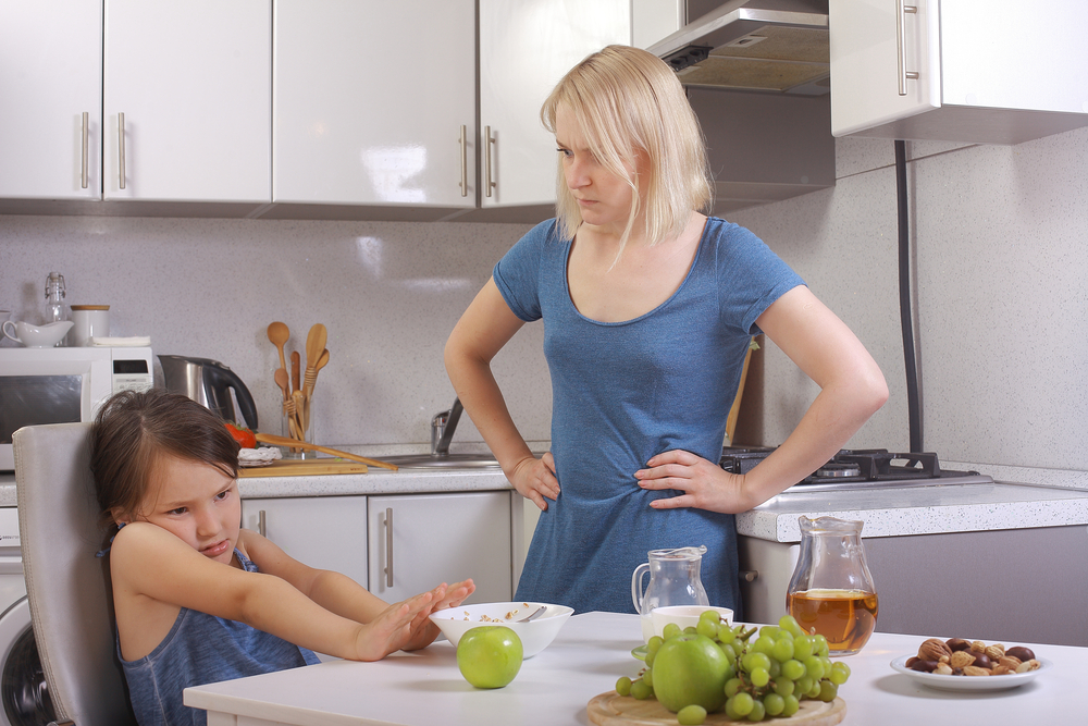 mom makes daughter eat healthy
