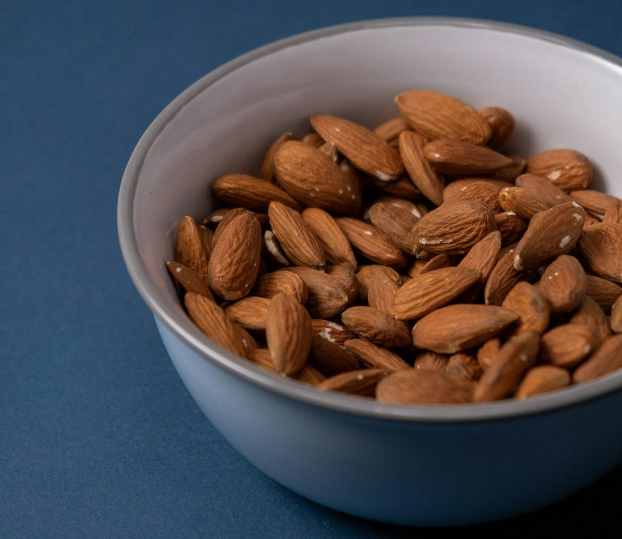 Close Up Photo of Almonds in White Ceramic Bowl
