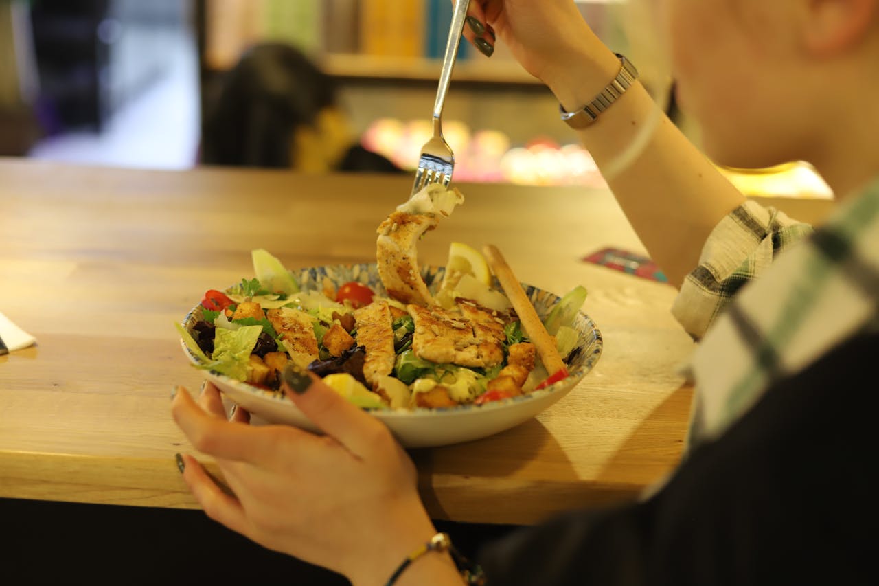 A Person Eating a Salad on a Plate