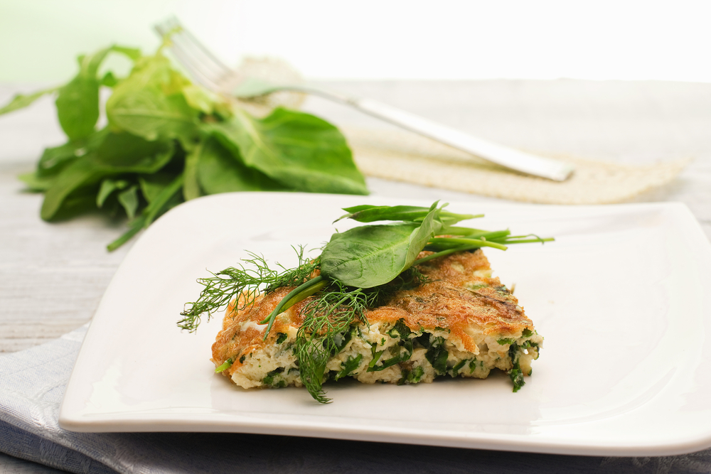 herbs mix omelet over ceramic plate