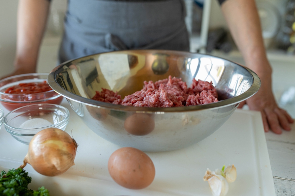 Woman with apron preparing meatloaf in the kitchen