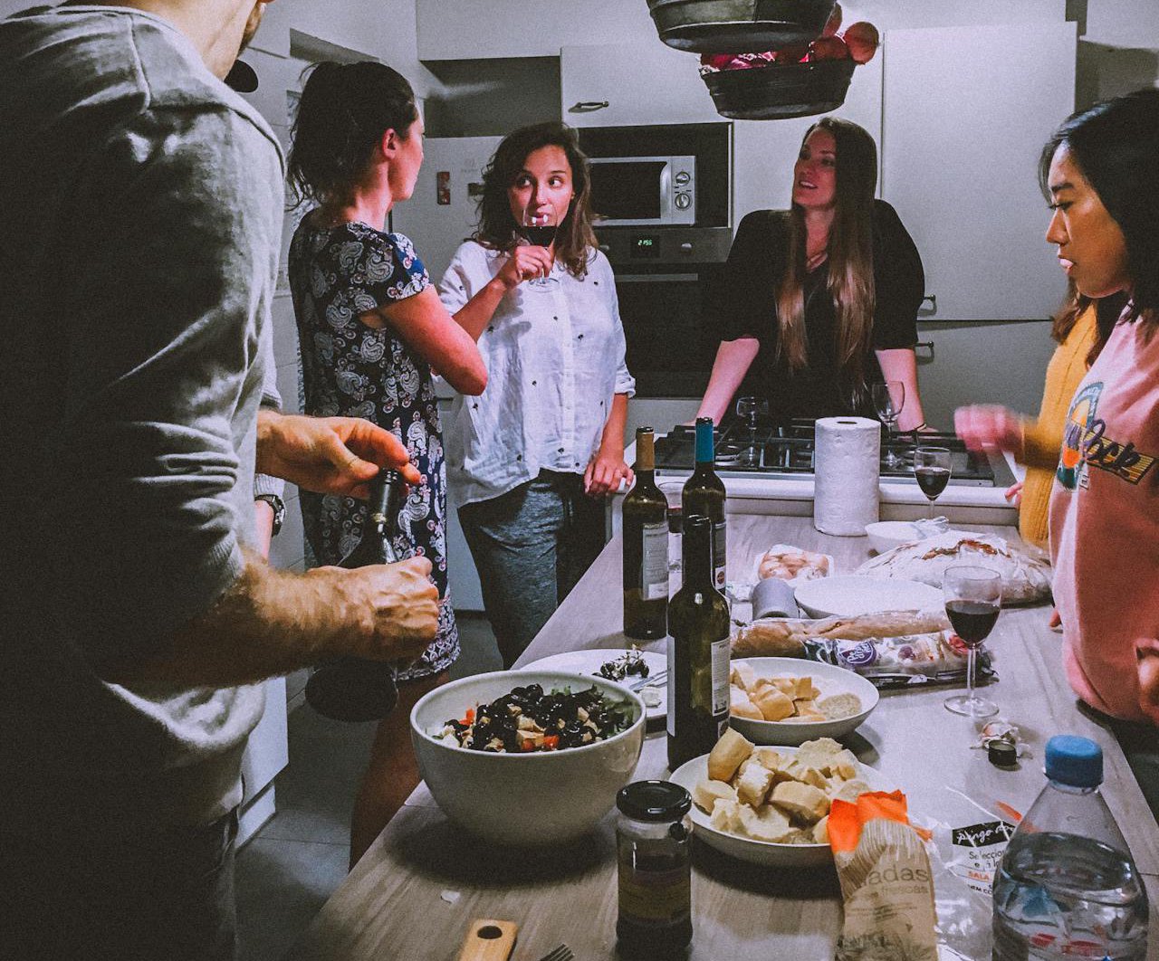 Men and Women Standing Infront of Dining Table