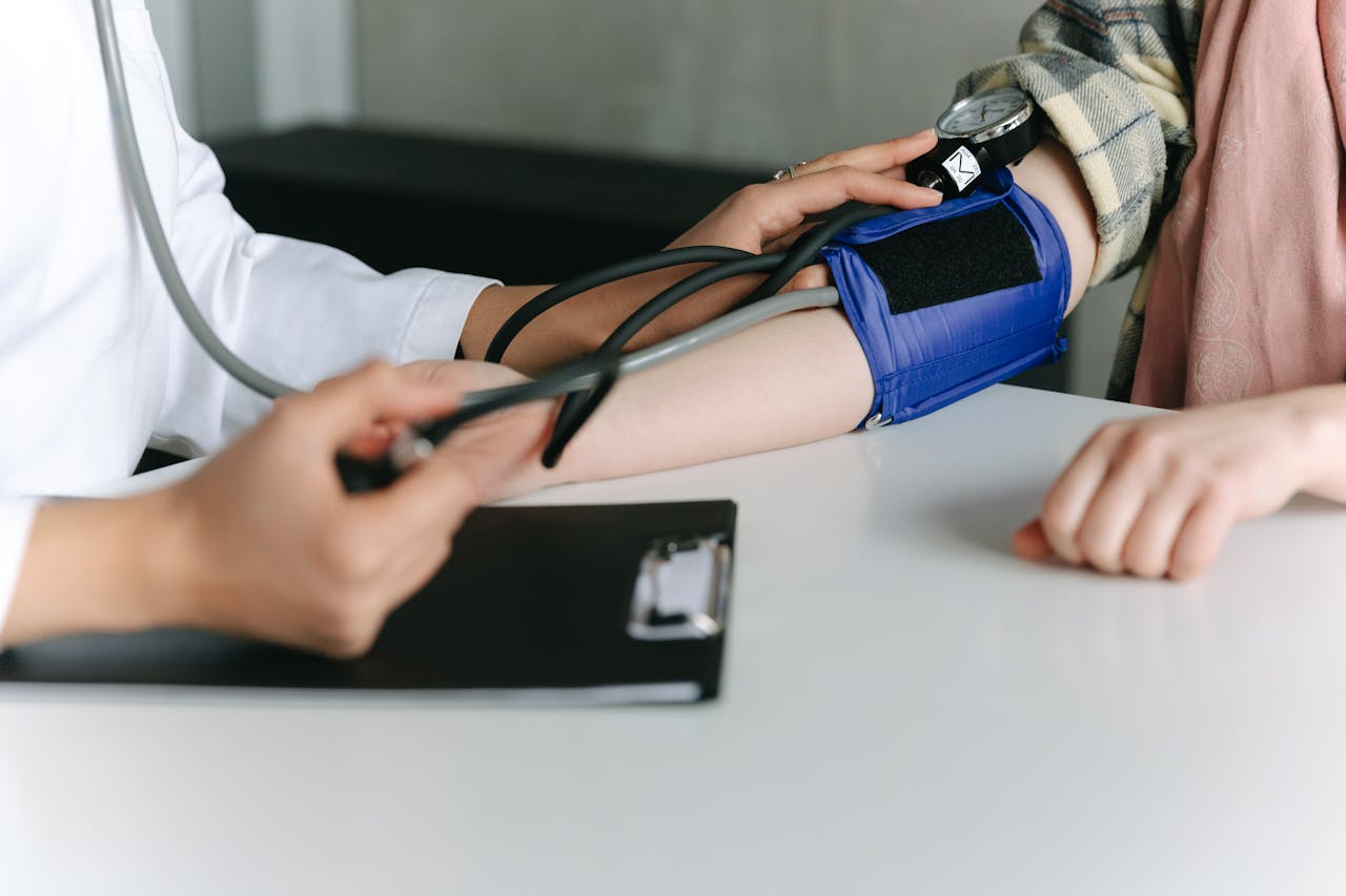 A Healthcare Worker Measuring a Patient's Blood Pressure