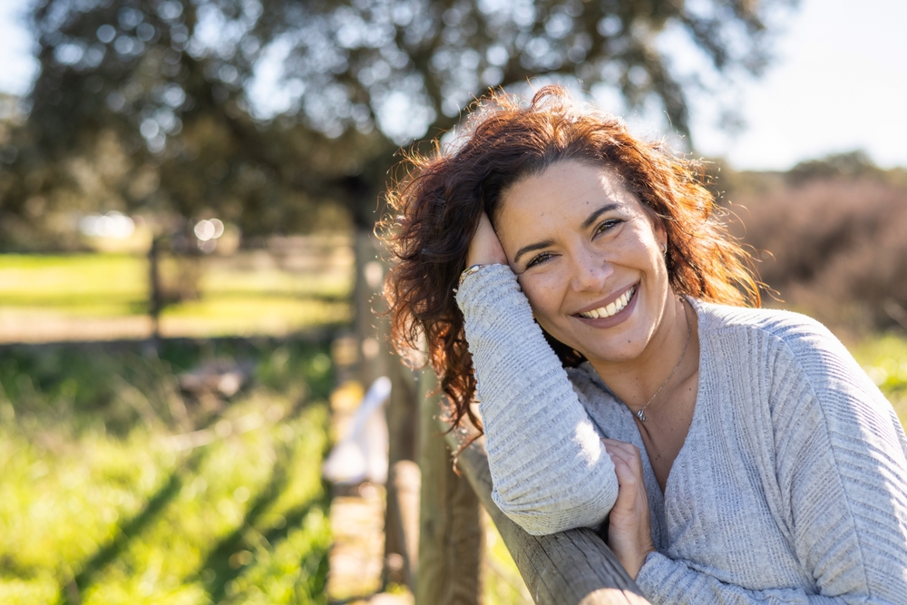 Happy Woman Smiling At Camera In A Field