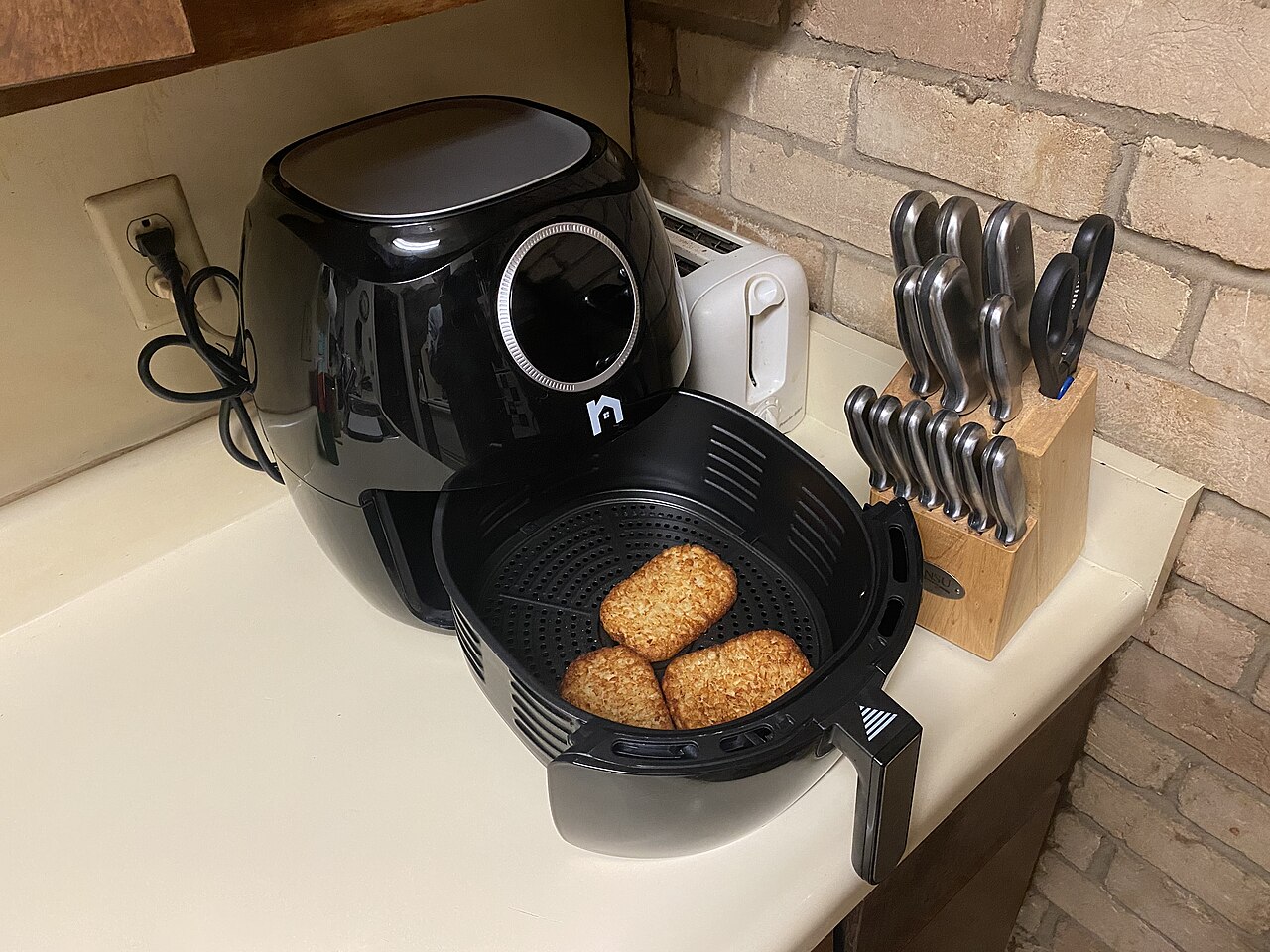Black Air Fryer on kitchen table.