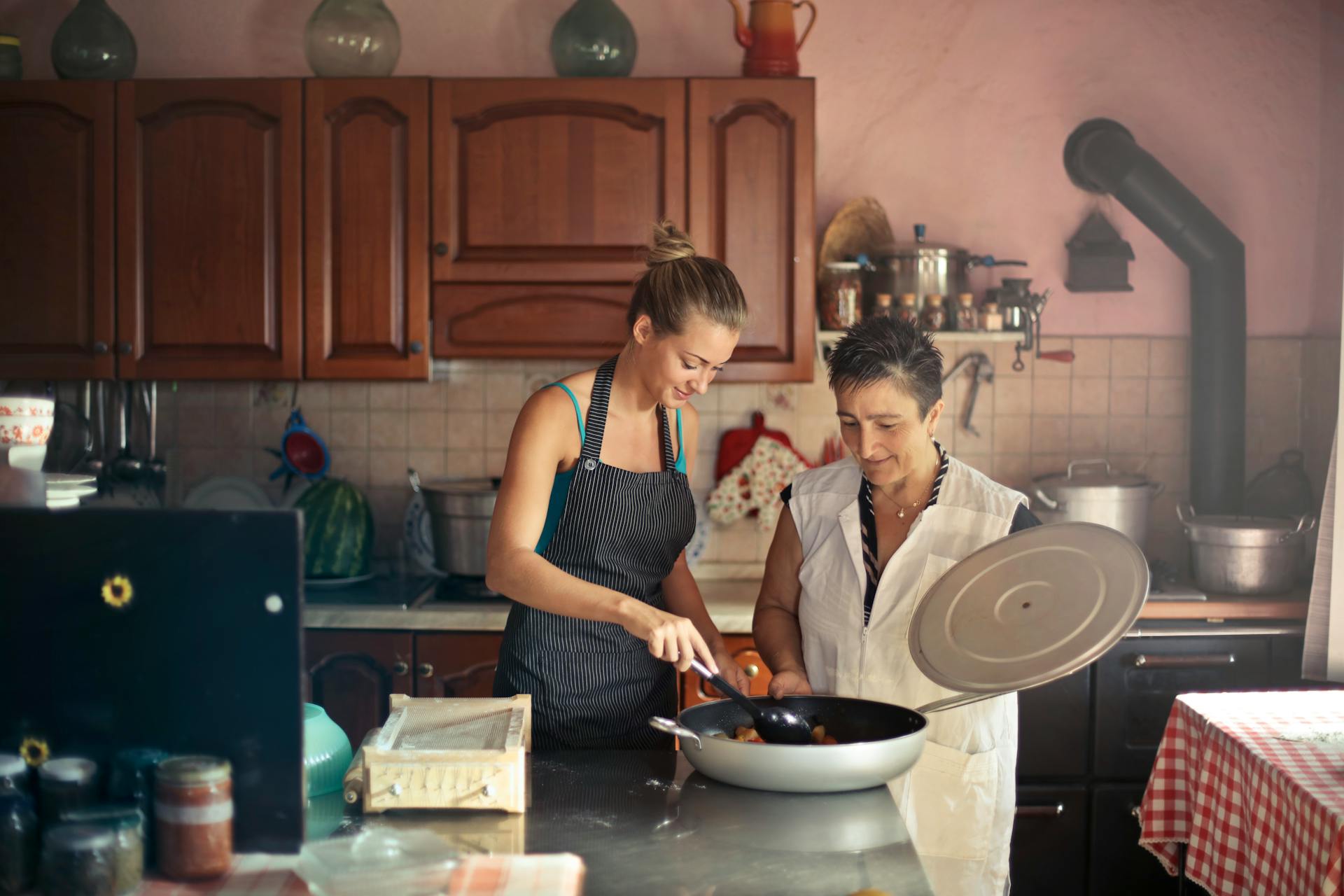 Two woman cooking in the kitchen.