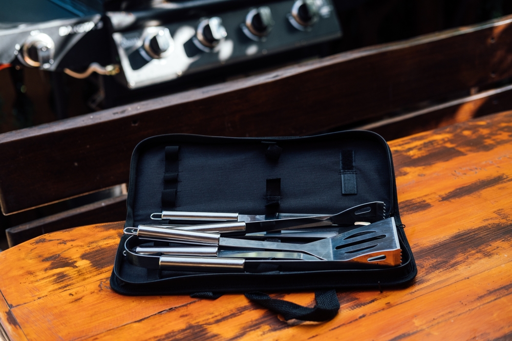 Grilling Tool Set on grill background. BBQ Utensils Set