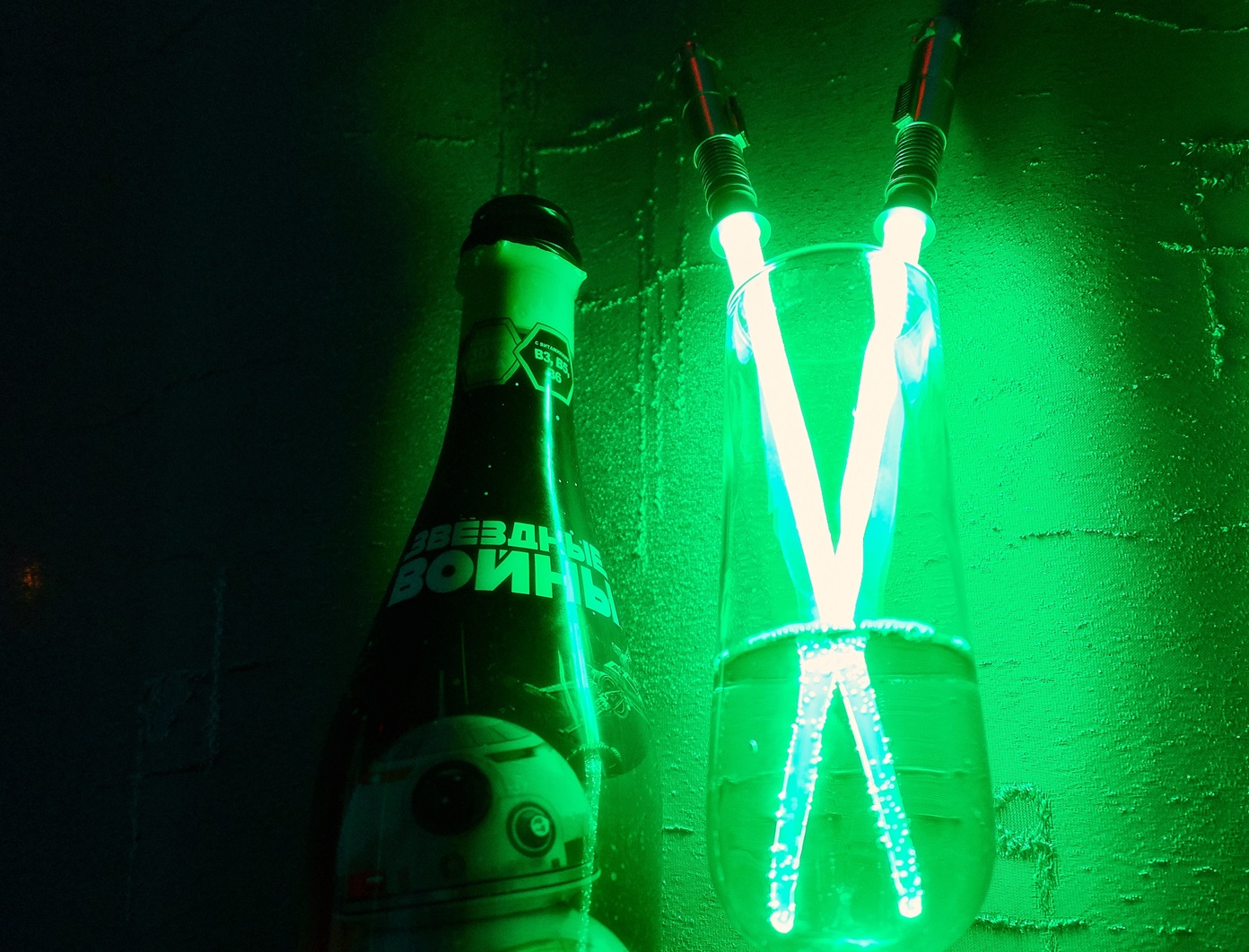 Green luminescence of crossed japanese chopsticks with led light in a glass