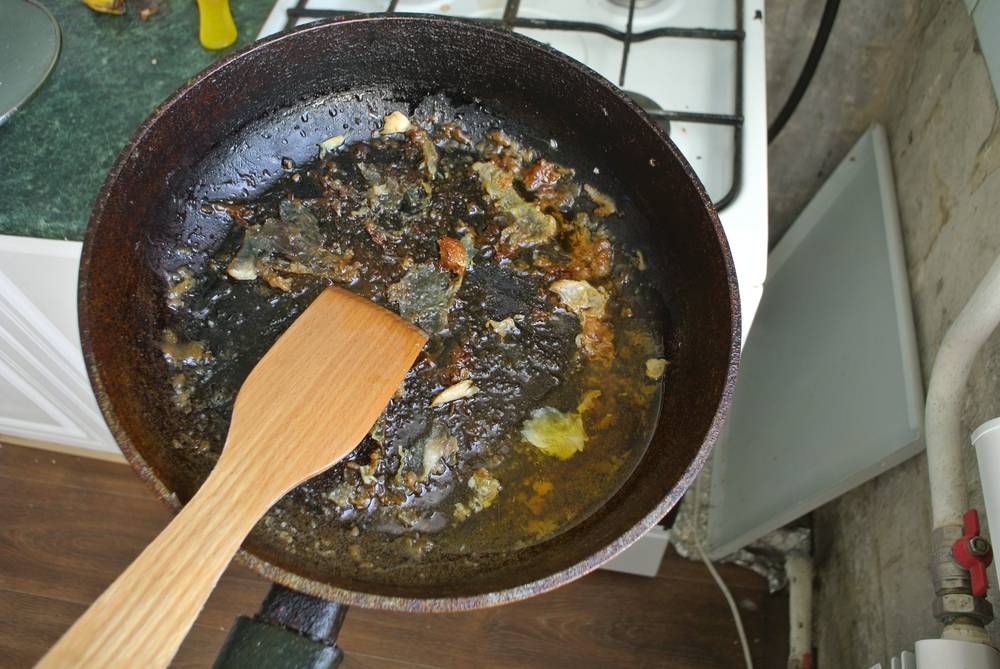 Dirty greasy dishes after frying meat.