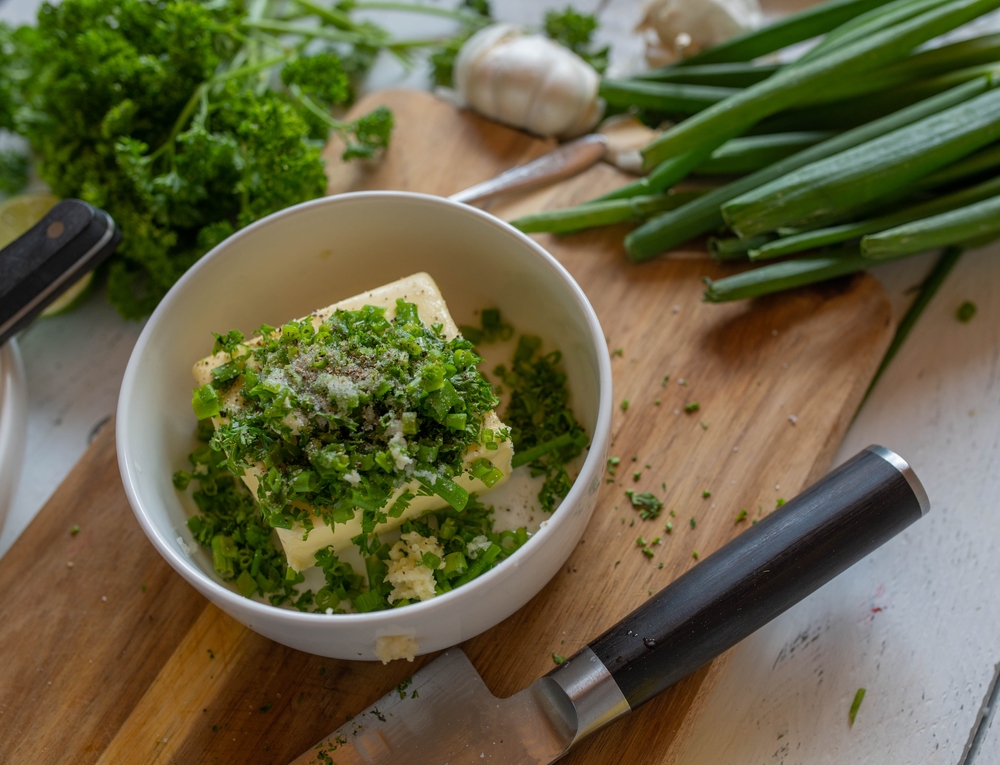making herb butter in a bowl