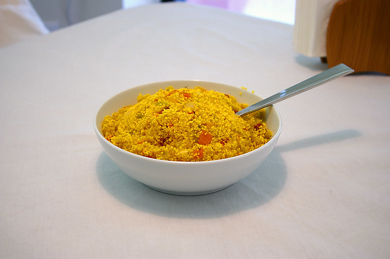Close Up Photo of Curried couscous on a white plate