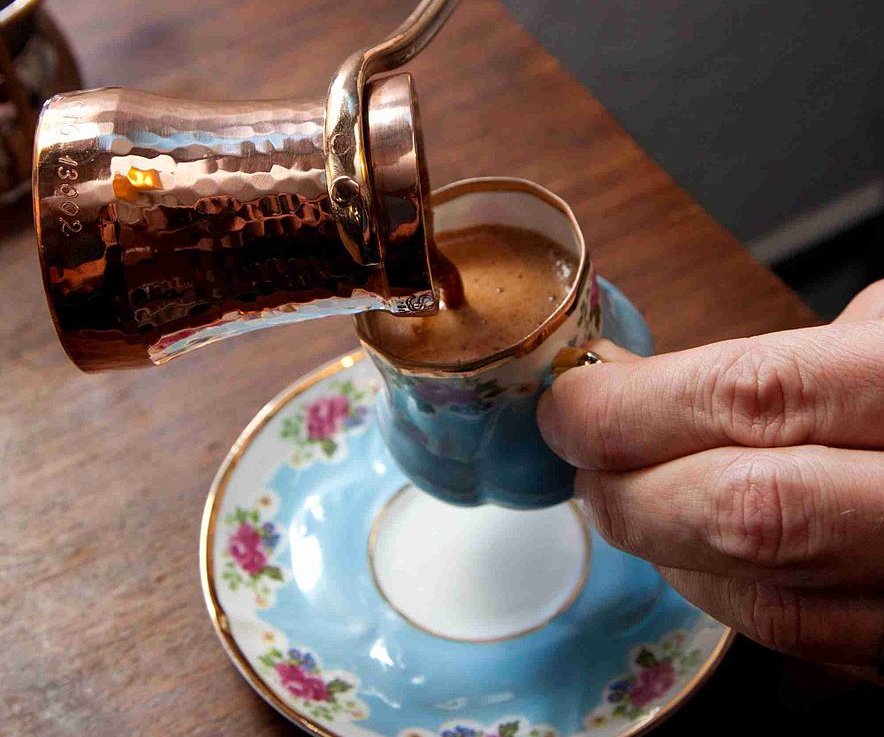 Turkish Coffee being poured from a copper cezve