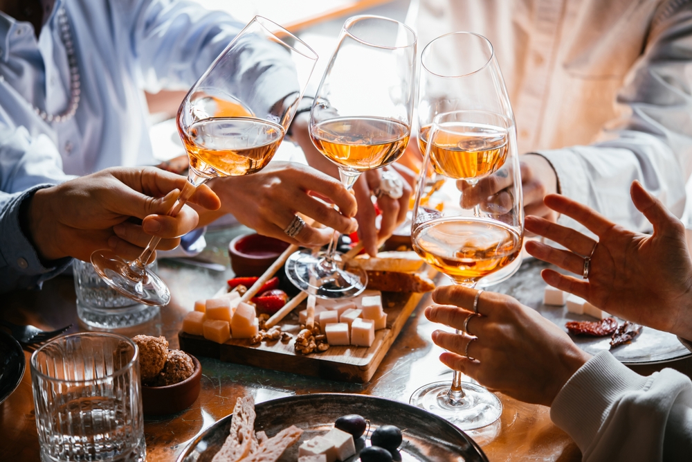 Friends having a dinner party with different kinds of appetizers