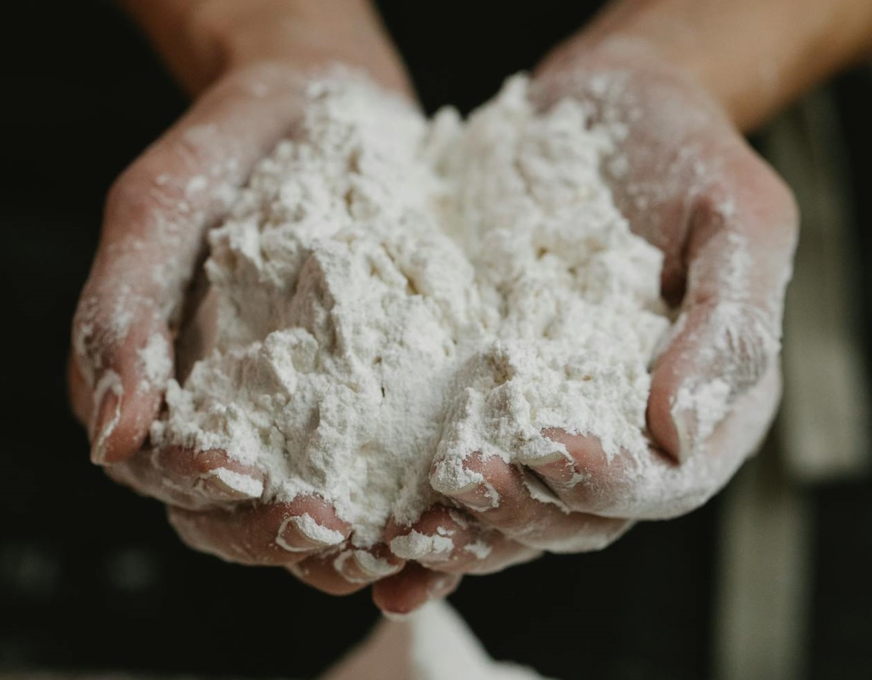 Woman showing wheat flour in hands