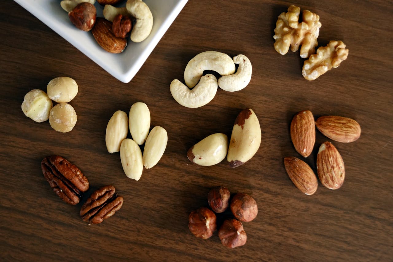 Variety of Brown Nuts on Brown Wooden Panel