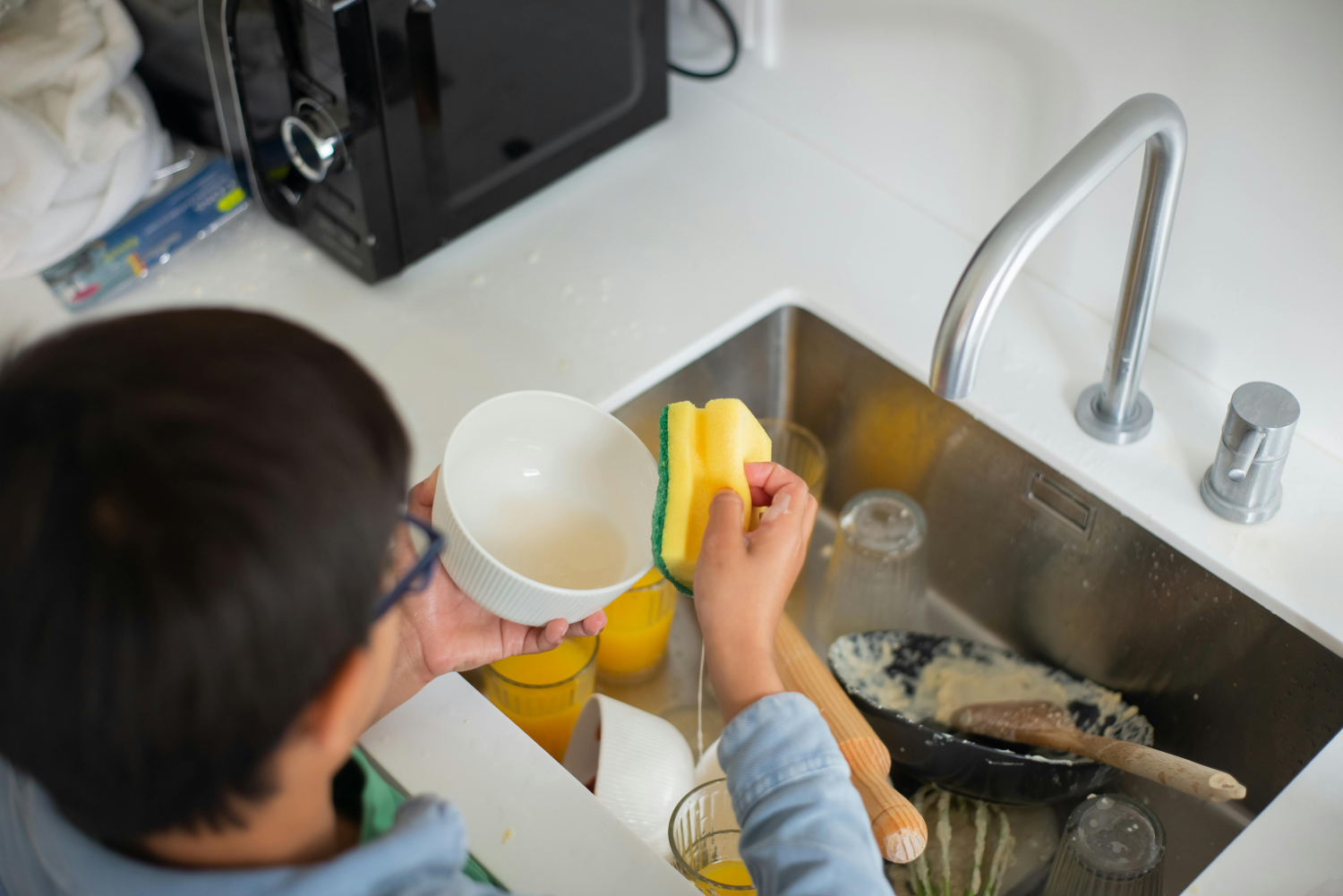 Boy cleaning the Dishes