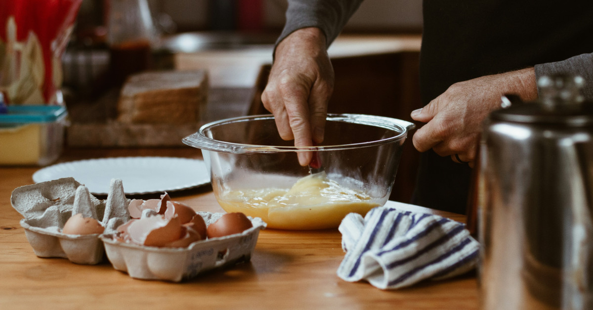 person holding clear glass bowl with brown liquid