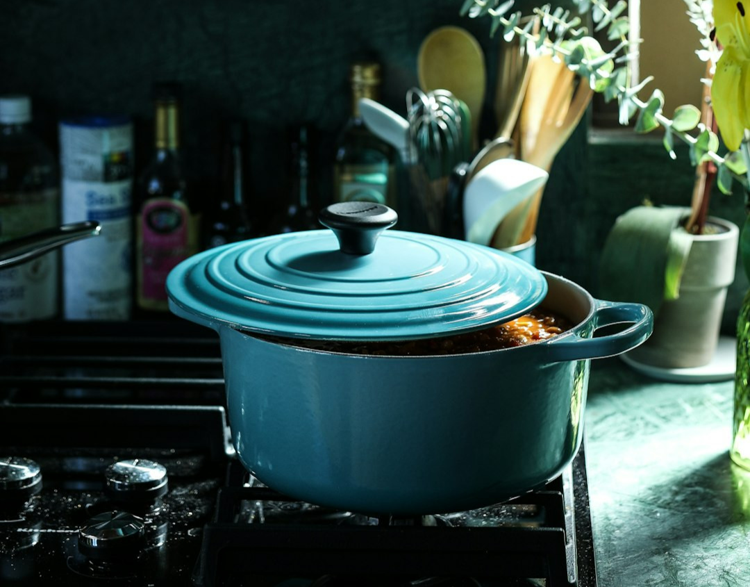 partly opened blue metal pot on stove