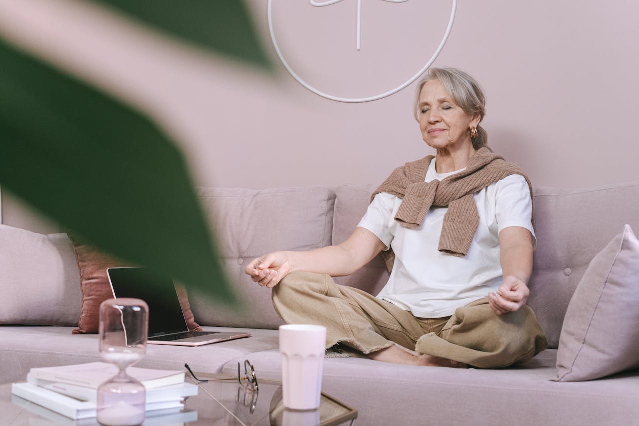 Photo of Woman in a white t-shirt and brown pants Sitting on the Couch