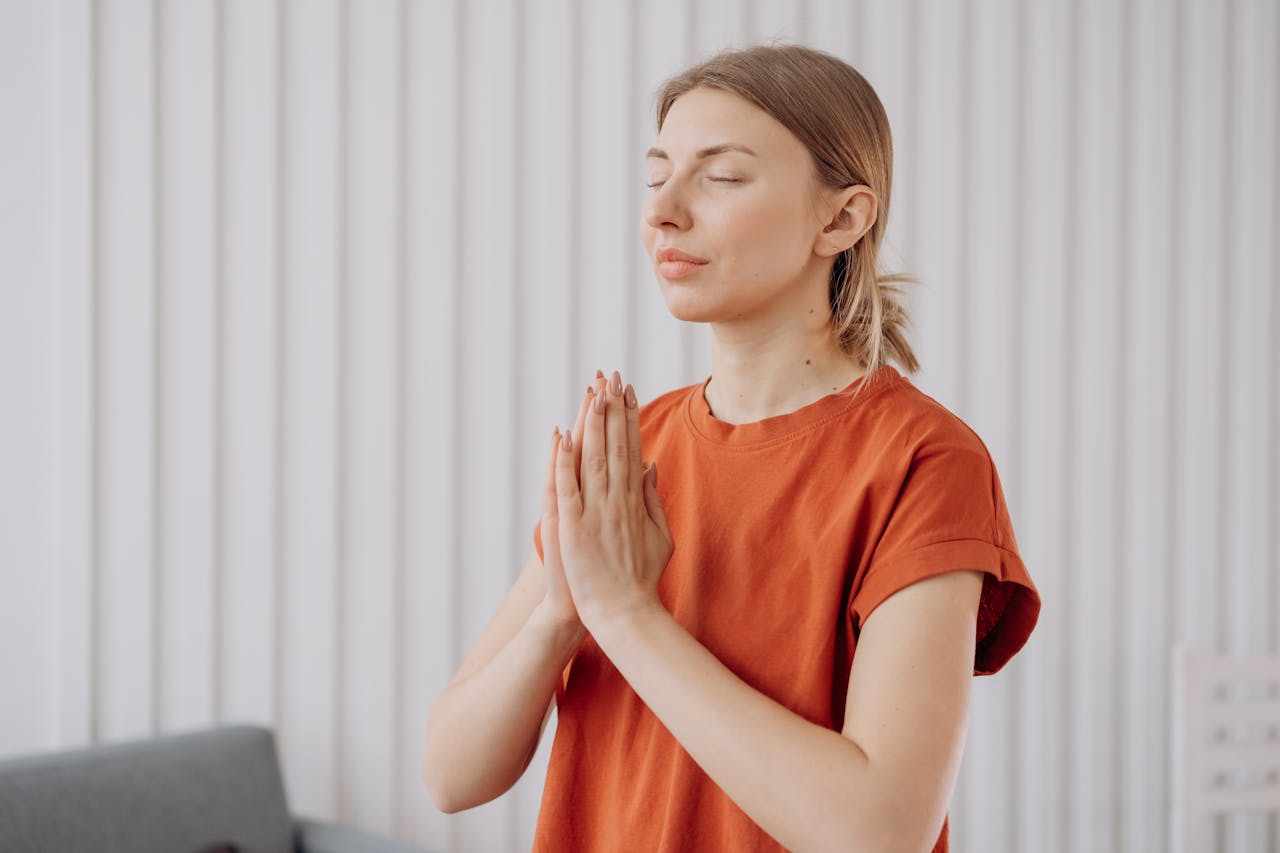 Photo of Woman in Red Crew Neck T-shirt Meditating